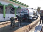 Menjaga Asa di Depan Rumah Ibadah, Kala Satgas TMMD ke-129 Kodim 0813 Bojonegoro Setia Merawat Jalan Desa Kesongo